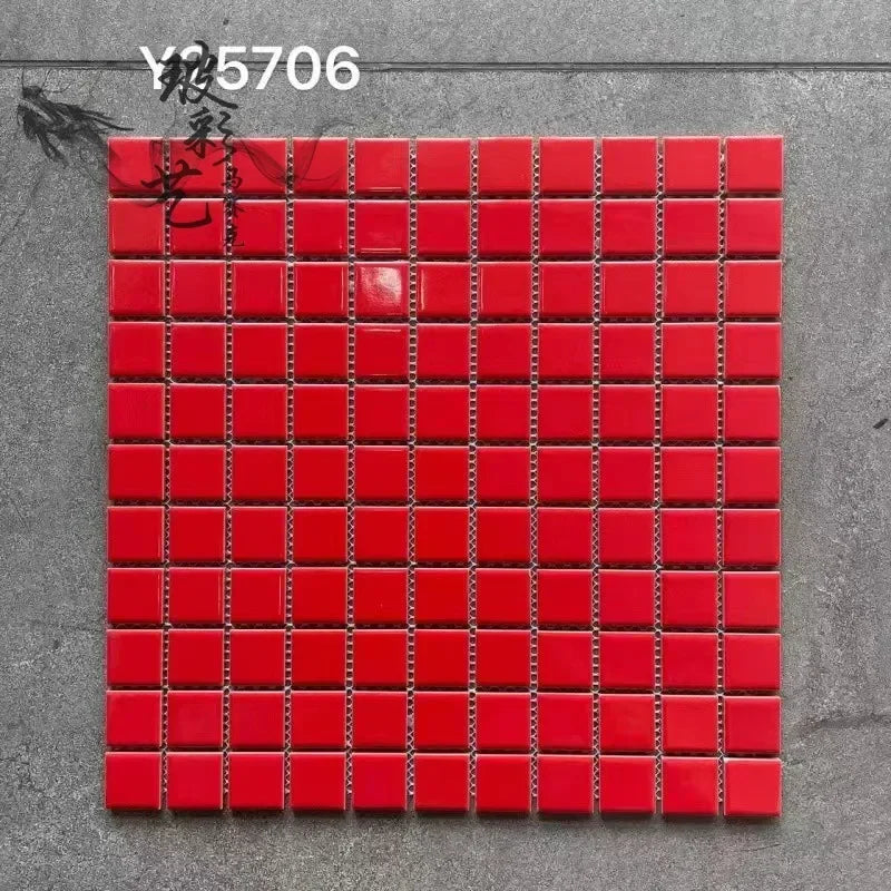 Ceramic mosaic tile sheet with glossy red square tiles on grid backing