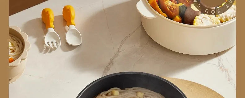 White electric cooking pot with lid open and food visible, viewed from above