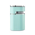 Compact light blue electric coffee grinder with modern cylindrical ribbed design and metallic silver trim.