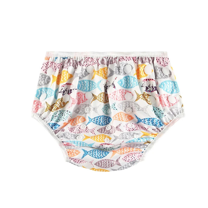 Reusable cloth baby diaper with colorful fish print pattern and adjustable snap buttons.