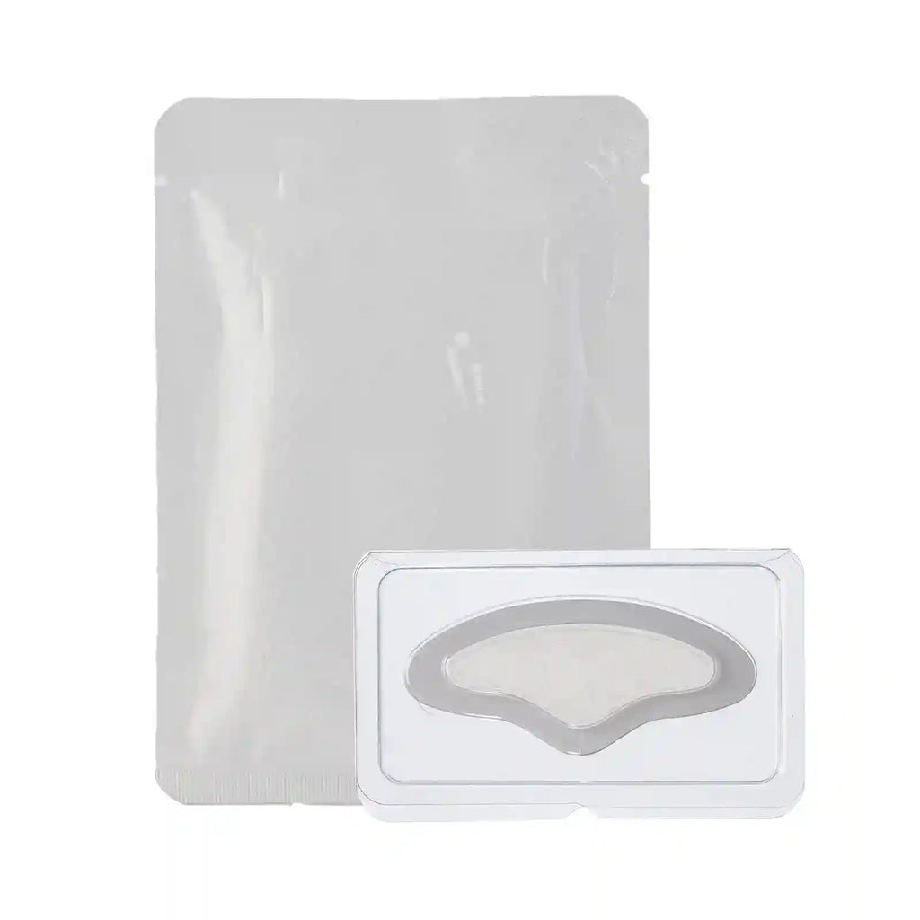 A white, rectangular product pouch beside a clear plastic tray containing a crescent-shaped microneedle forehead patch.