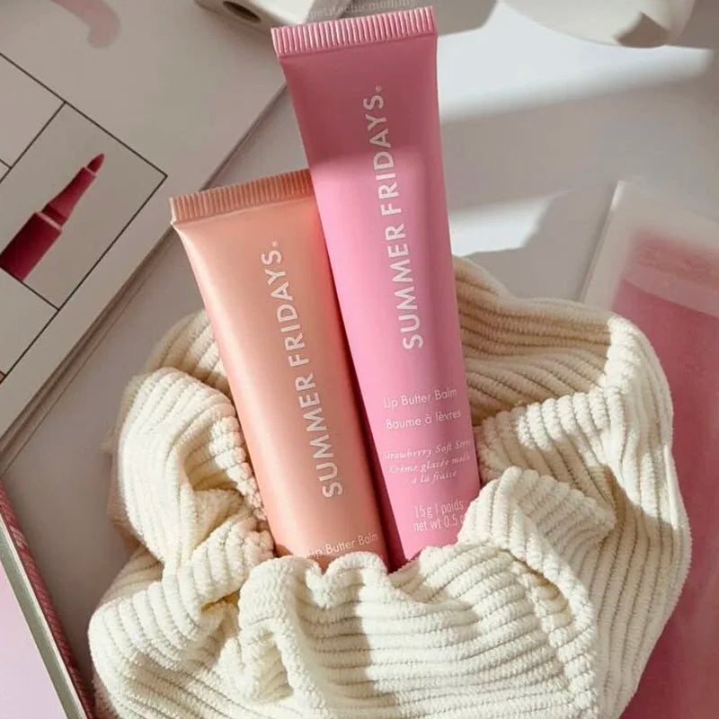 Summer Fridays moisturizing lip butter balm tubes in vanilla beige and pink, featuring a smooth, glossy finish.