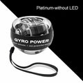 Platinum wrist exerciser ball with a clear plastic shell, internal metal rotor, and black safety wrist strap.