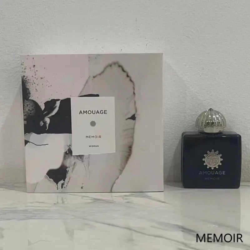 Amouage Memoir Woman 100ml Eau de Parfum in a dark navy glass bottle with a silver cap and artistic gift box.