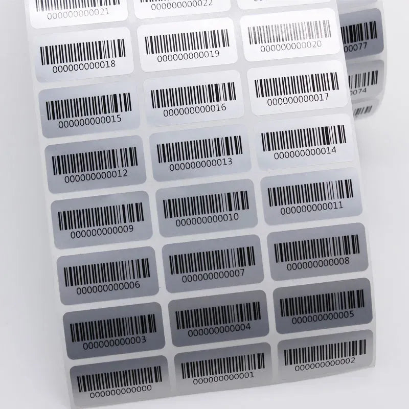 Sheet of barcode inventory number labels with rounded corners, black print on white.