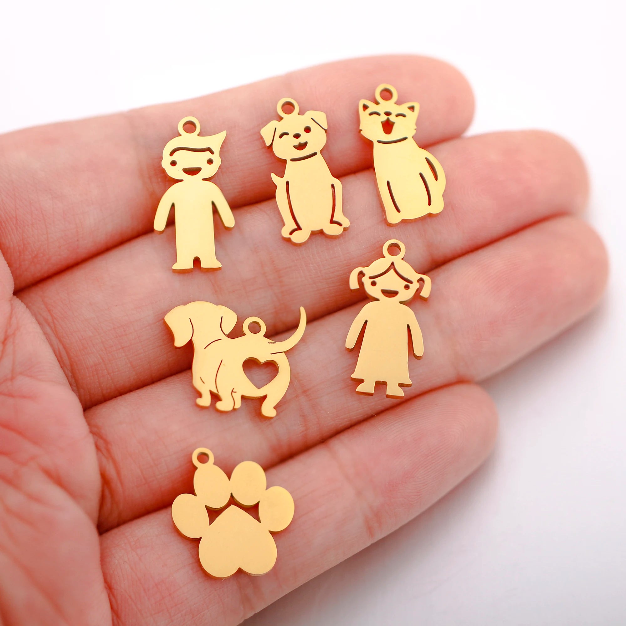 Gold stainless steel dog, cat, and paw charms for DIY pet-themed jewelry making, necklaces, and bracelets.