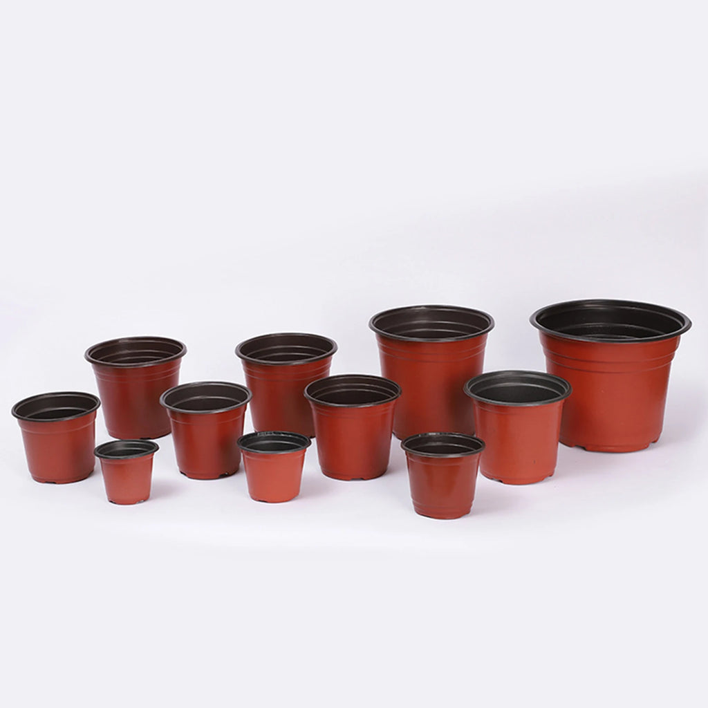 Set of red plastic nursery pots in mixed sizes, black rims and open tops