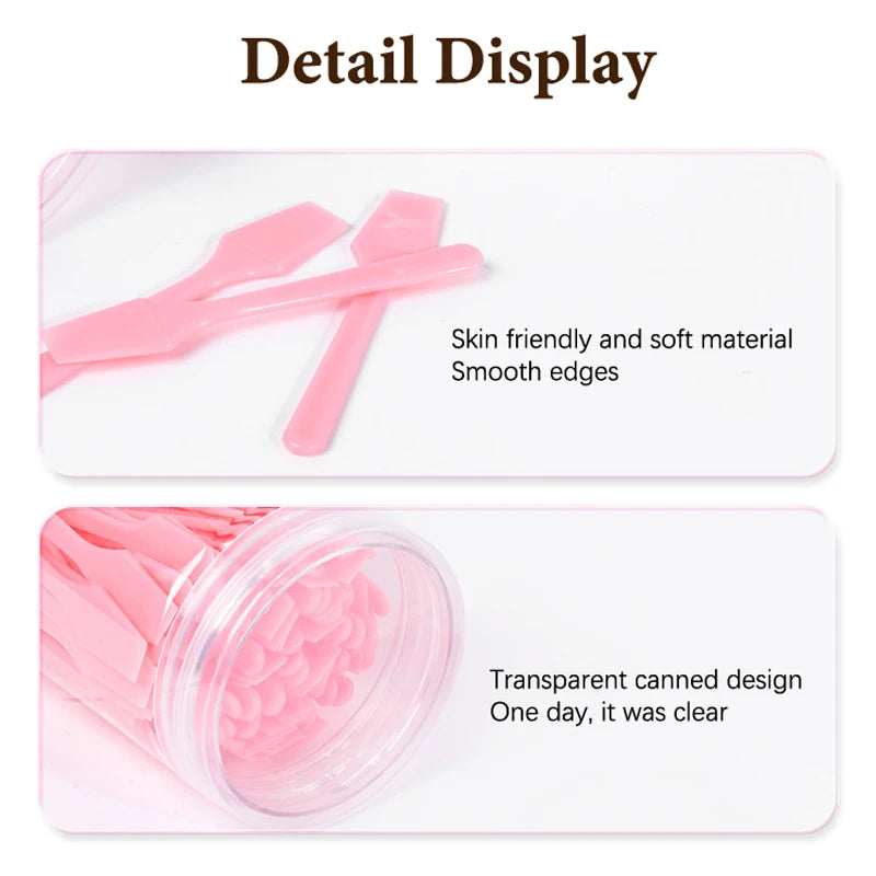 Set of pink plastic cosmetic spatulas with smooth edges in a clear storage container.