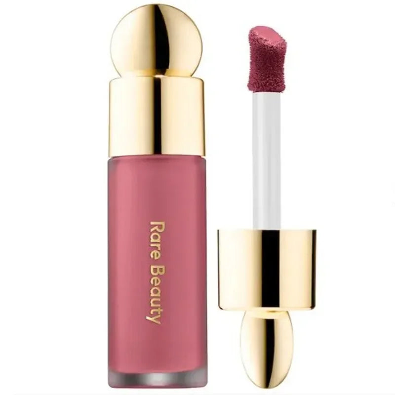 Rare Beauty matte liquid lipstick in a rich mauve shade with a smooth applicator and elegant gold-capped bottle.