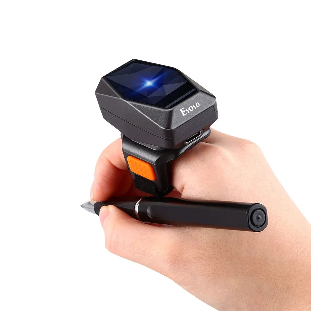 Close-up of black wearable ring barcode scanner with blue-lit scan window and orange base
