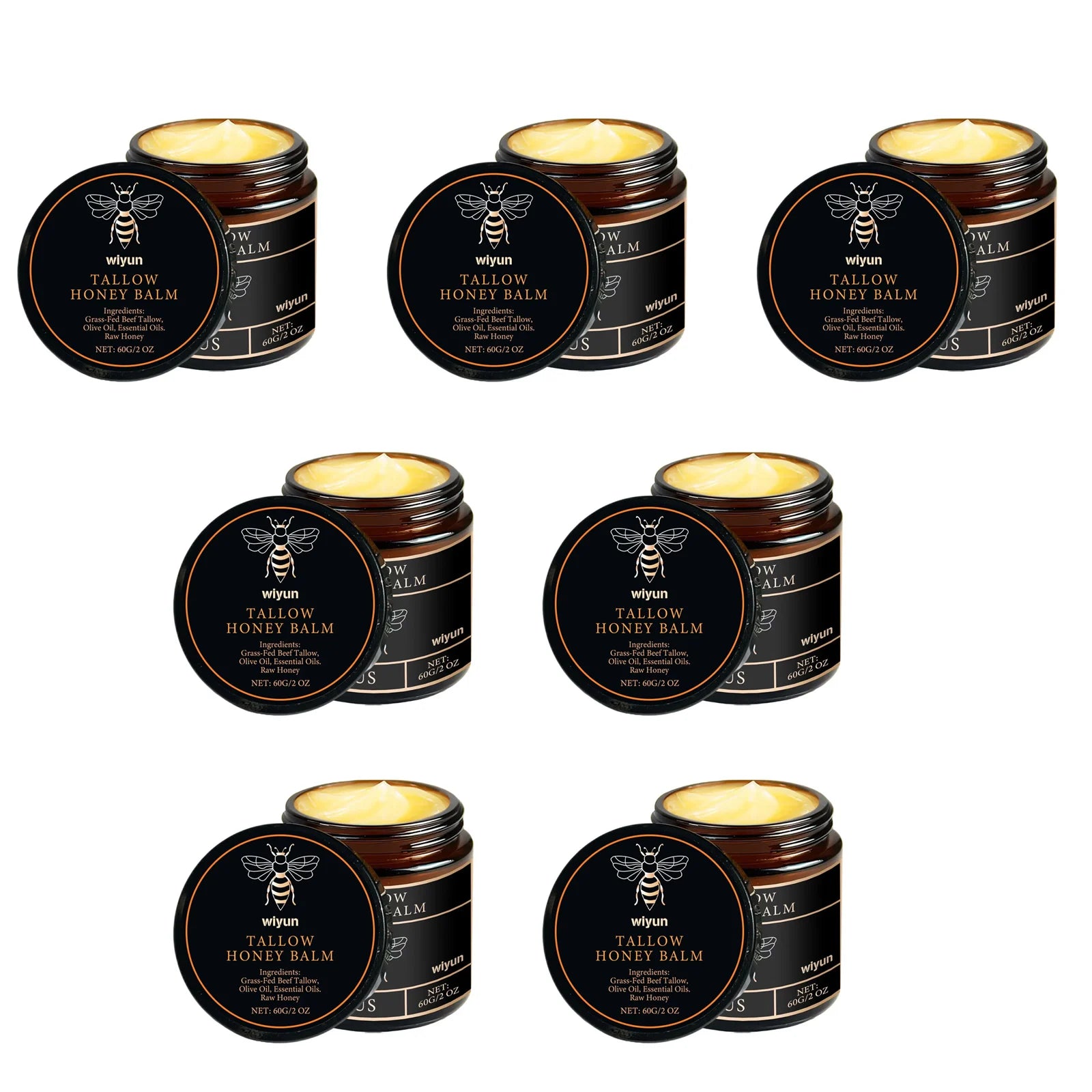 Honey tallow balm tins set, multiple black round tins with gold logo; several lids open