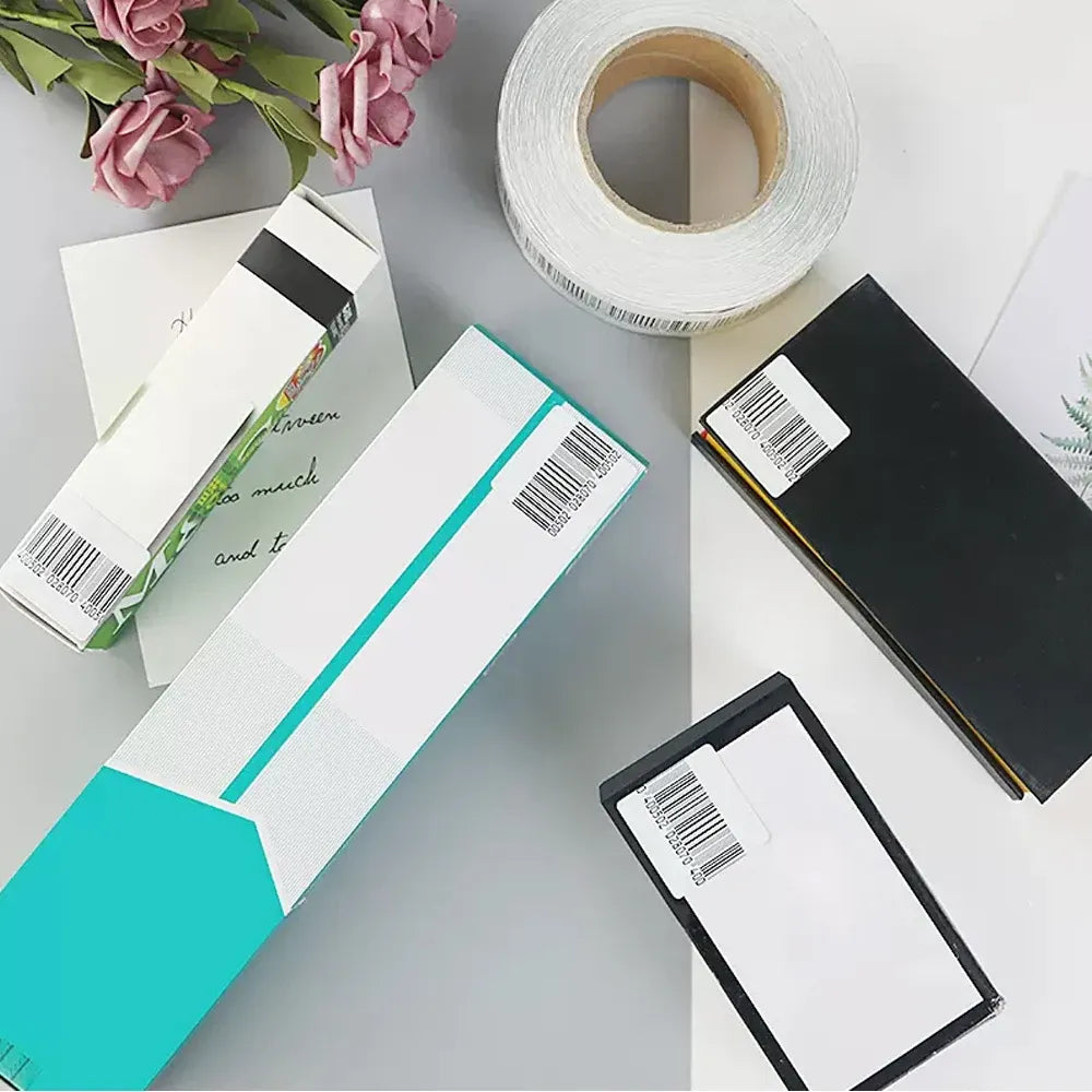 White and turquoise security label cards with barcode stickers and tape roll
