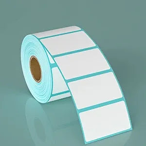 Close-up of a white thermal label roll with light-blue outline and blank label faces