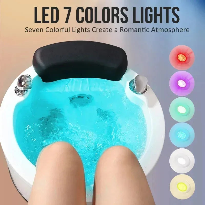 Hydro-massage foot spa with blue water and black headrest, glowing LED lights