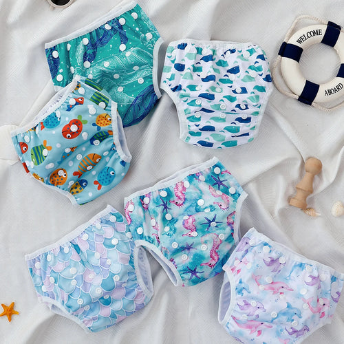 Set of 6 reusable baby swim diapers with ocean-themed patterns and adjustable snap closures for infants.