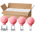 Four pink rubber-bulb facial cupping tools of varying sizes in front of an open cardboard shipping box.