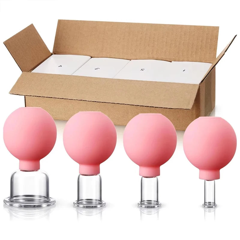 Four pink rubber-bulb facial cupping tools of varying sizes in front of an open cardboard shipping box.