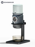 Starseeker manual espresso maker with gray and black finish, integrated pressure gauge, and glass catch cup on stand.