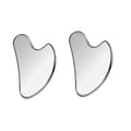 Two silver, polished stainless steel gua sha facial massage tools with a smooth, heart-shaped contoured design.