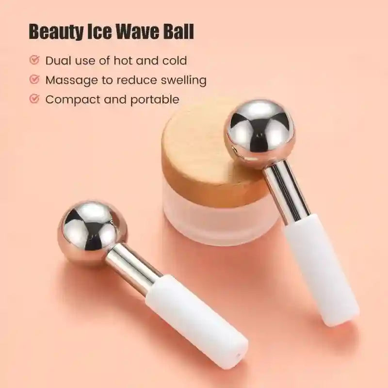Two stainless steel ice globes with white handles, next to a small container with a wooden lid on a peach background.
