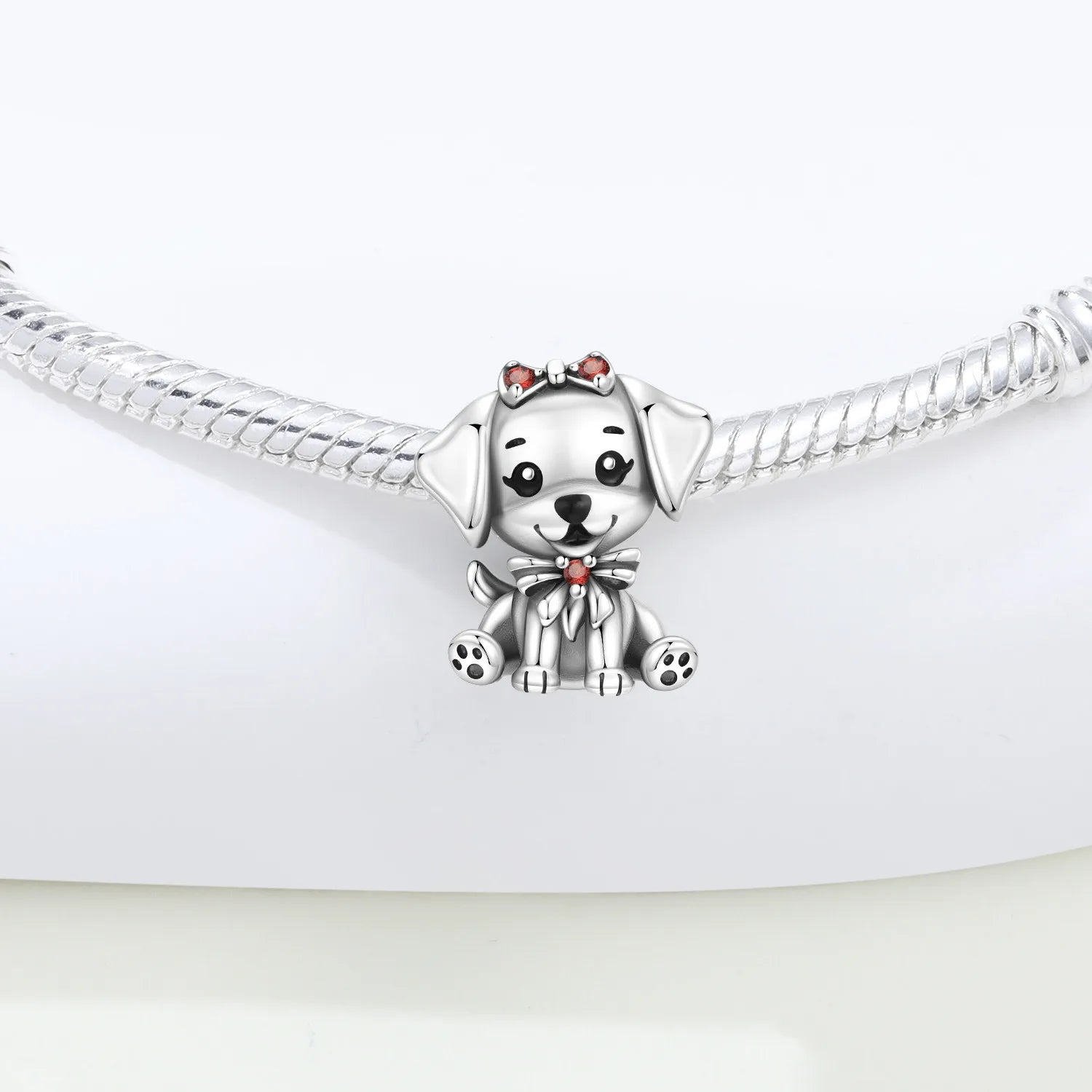 925 sterling silver puppy dog charm with red bow on bracelet for custom pet jewelry gifts.