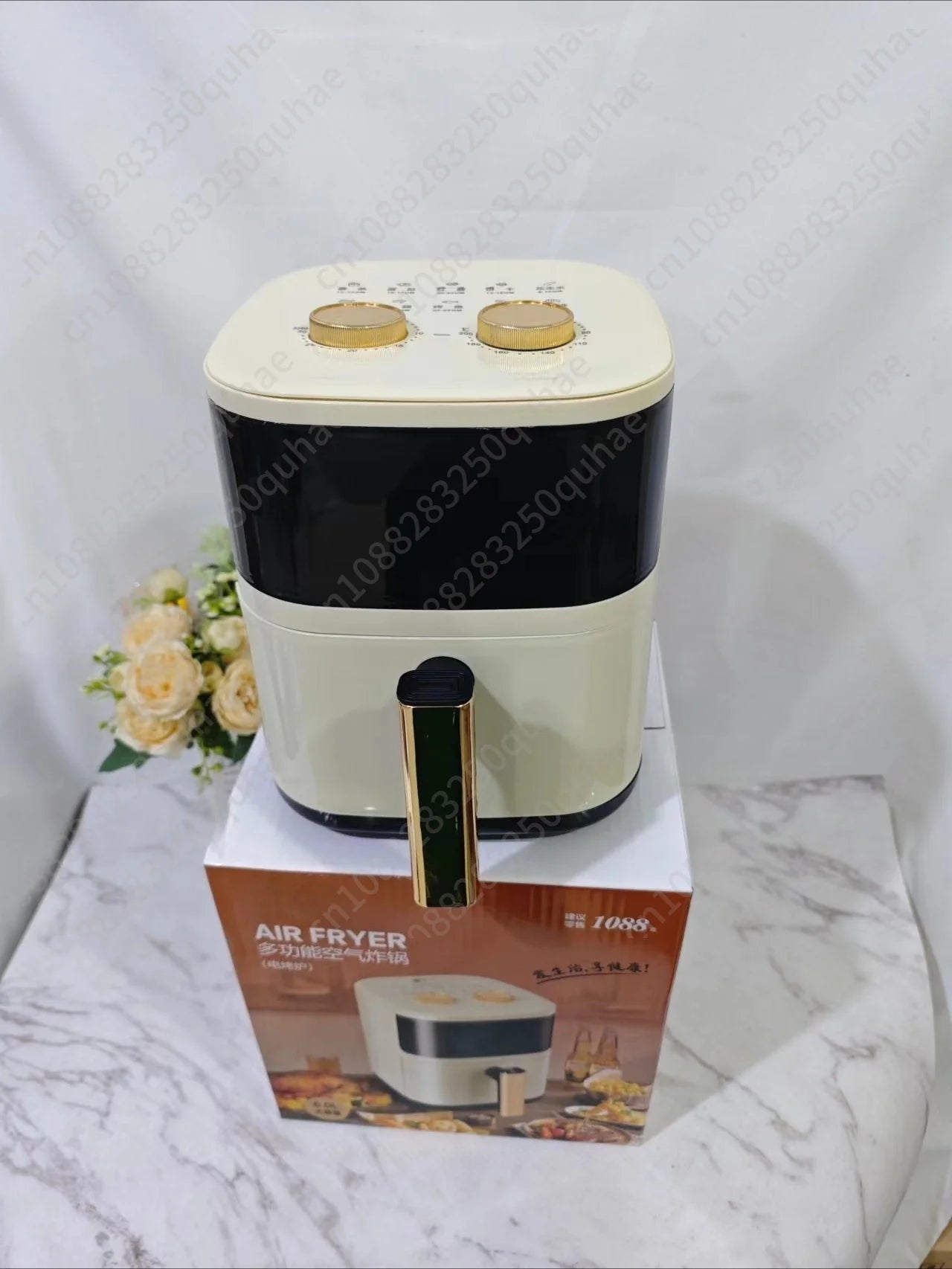Cream and black countertop air fryer with gold pull handle and dual top knobs