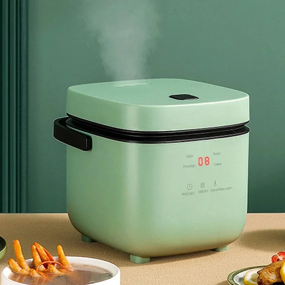 Mini electric rice cooker with green body, front display, and black rim lid.