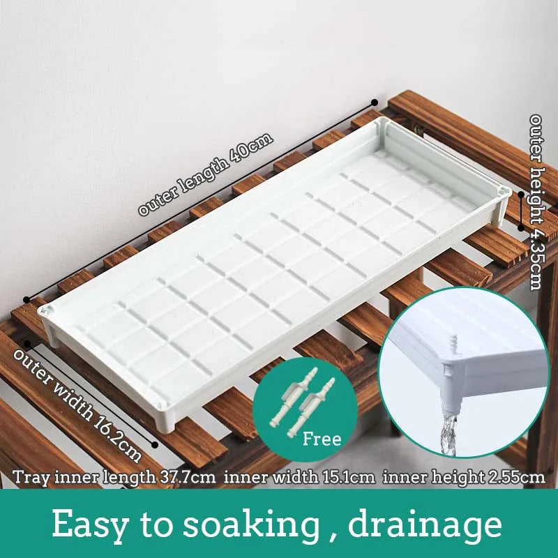 White plastic drainage tray with grid pattern cells, long rectangular tray for windowsills.
