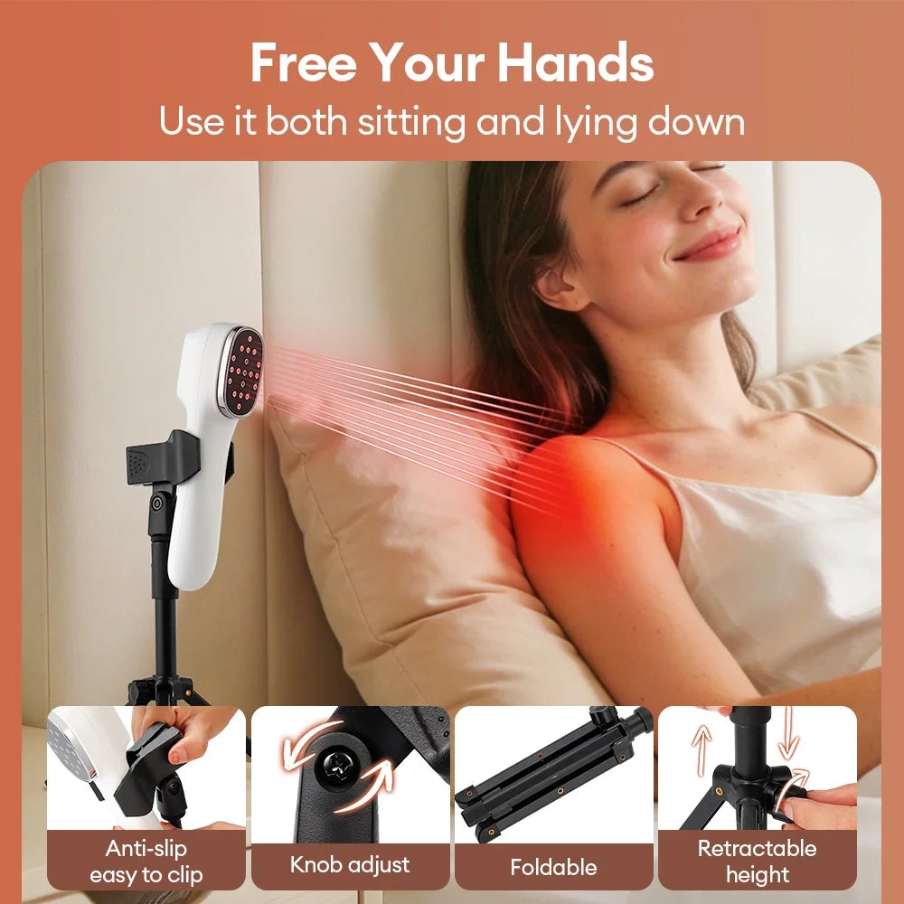 White handheld infrared therapy device on a foldable, height-adjustable black tripod stand treating a woman's shoulder.