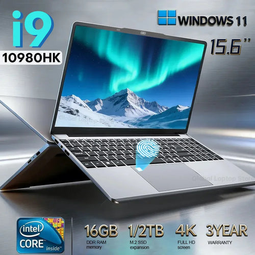 Silver 15.6-inch laptop with thin bezels, black keyboard, large trackpad, and side ports, against a metallic background.