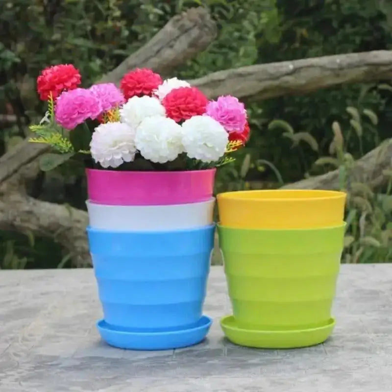 Pink and blue plastic flower pots with decorative flowers