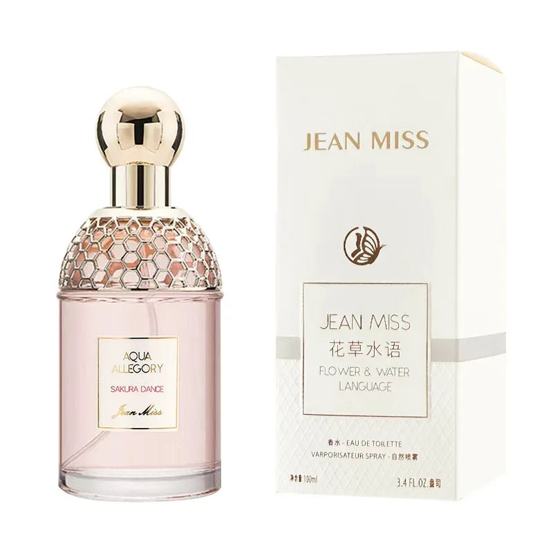 Jean Miss Aqua Allegory Sakura Dance EDT 100ml: floral perfume, round gold-capped bottle with honeycomb texture.