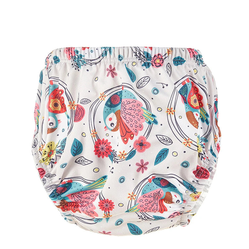 Reusable cloth baby diaper with colorful bird and floral print pattern.