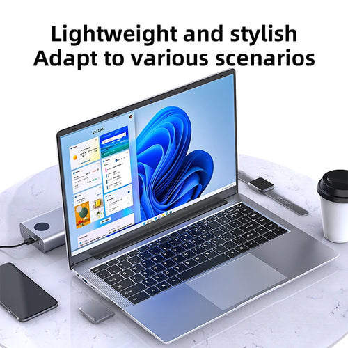 Silver 14.1-inch laptop with thin bezels, black keyboard, large trackpad, and side ports, displaying Windows 11.
