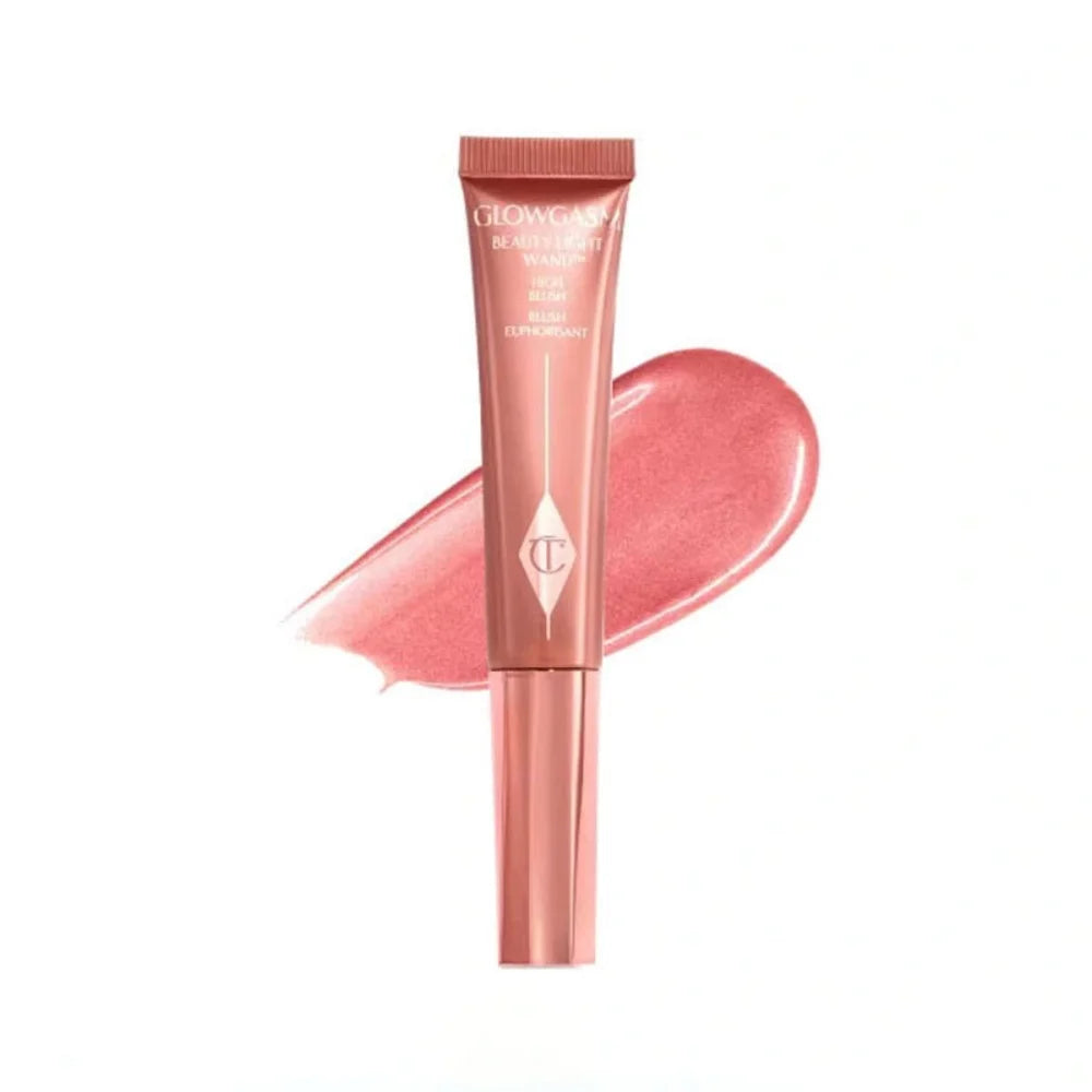 Charlotte Tilbury Glowgasm Beauty Light Wand liquid blush in pink with a shimmering, creamy texture swatch.
