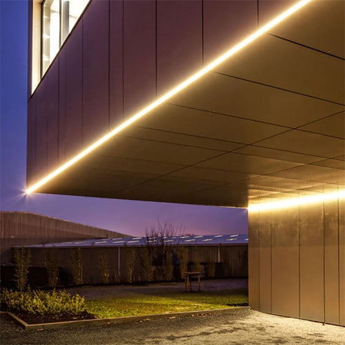 Outdoor warm white LED strip installed along an exterior wall corner