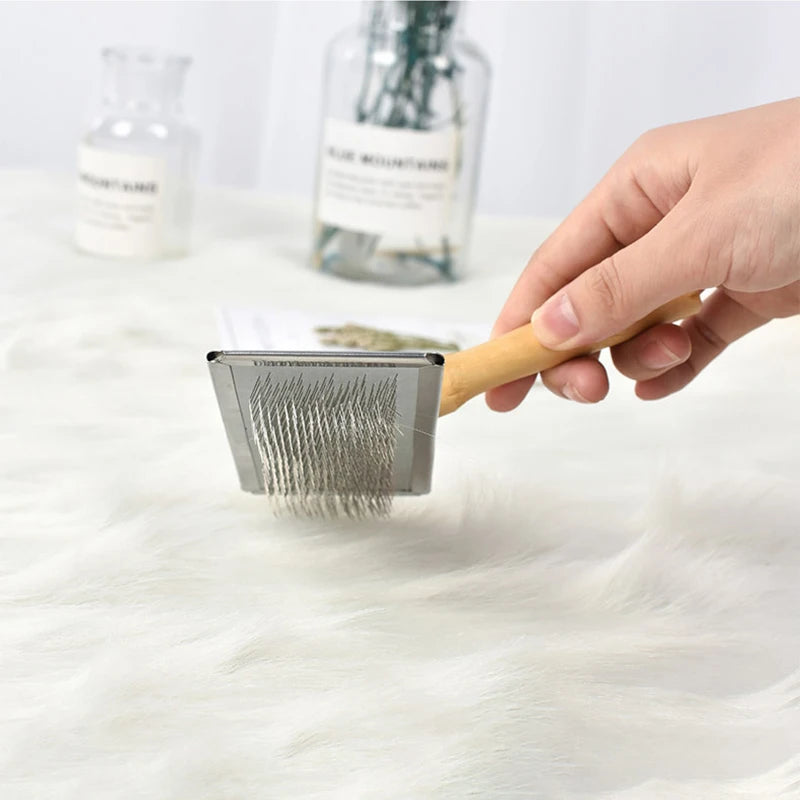 Wooden handle metal lint remover brush for removing pet hair from clothing and upholstery.
