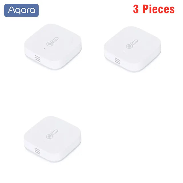 Three small, white, square-shaped Aqara smart sensors with a thermometer icon, shown against a plain white background.