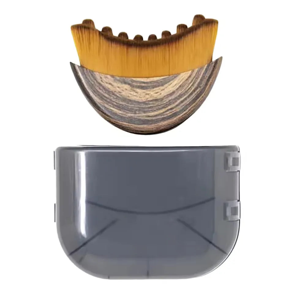 Curved facial brush with soft gold bristles, wood-grain handle, and a transparent grey protective cover on white.