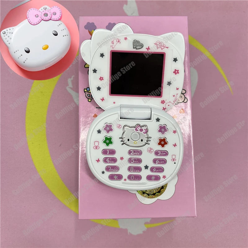 White plastic Hello Kitty-shaped flip phone with star and flower designs, featuring a keypad and small display screen.