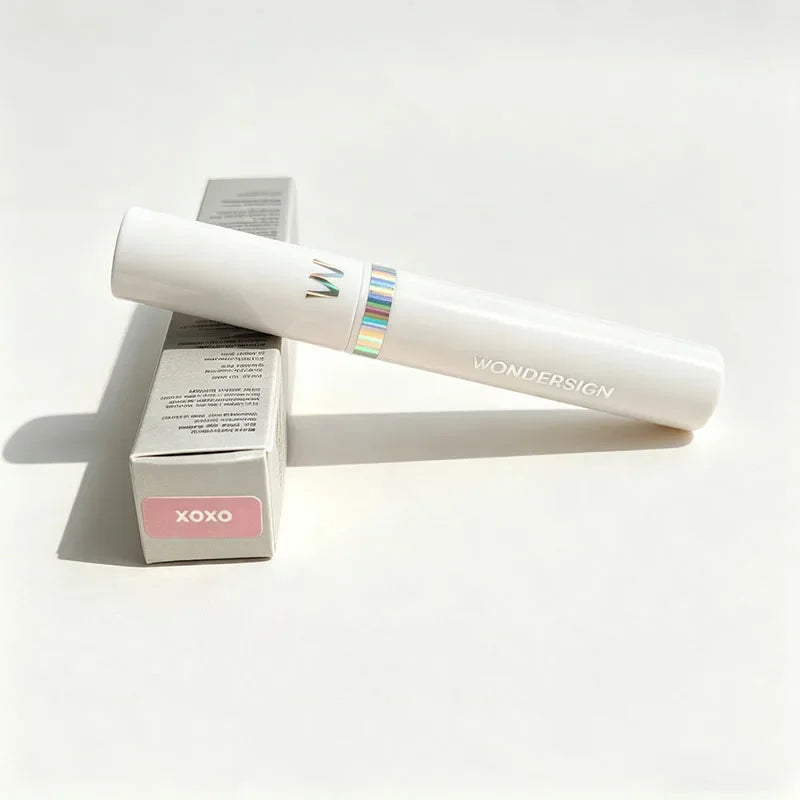 Wonderskin XOXO peel-off tattoo lip stain in white tube with holographic accent and matching product packaging box.