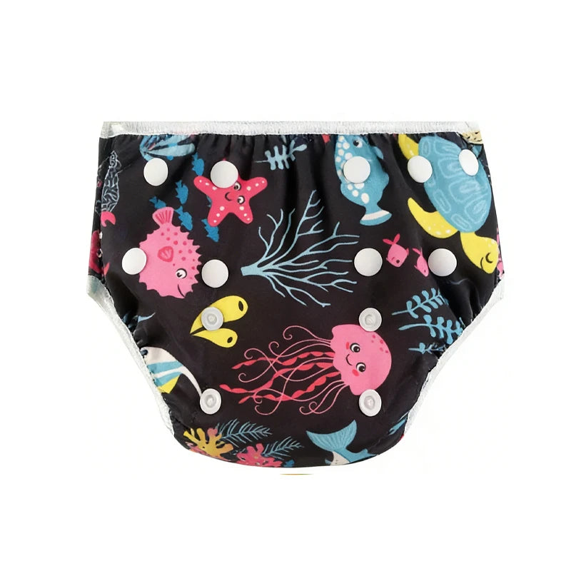 Reusable cloth baby diaper with adjustable snaps and black ocean sea life print.