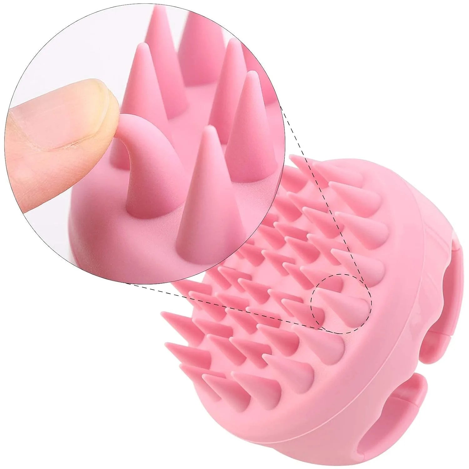 Pink silicone scalp massager brush with flexible, conical bristles, showing a close-up of a finger bending a bristle.