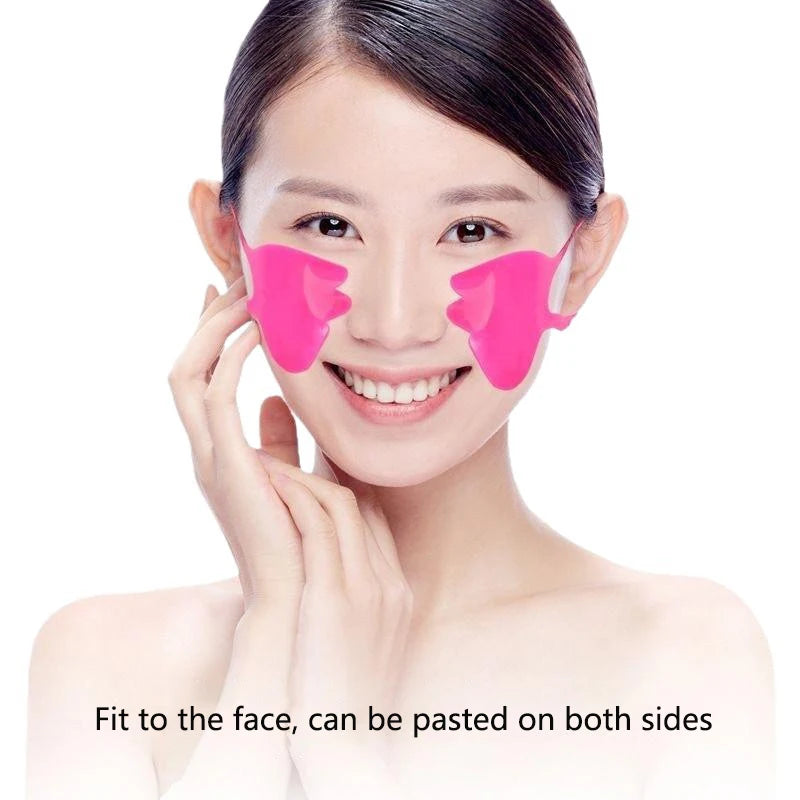 A woman wearing bright pink, butterfly-shaped silicone anti-wrinkle patches on her nasolabial folds.