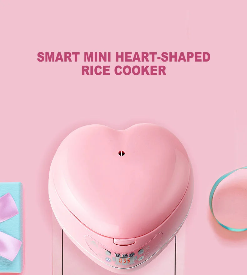 Pink heart-shaped mini rice cooker from above with top controls visible.