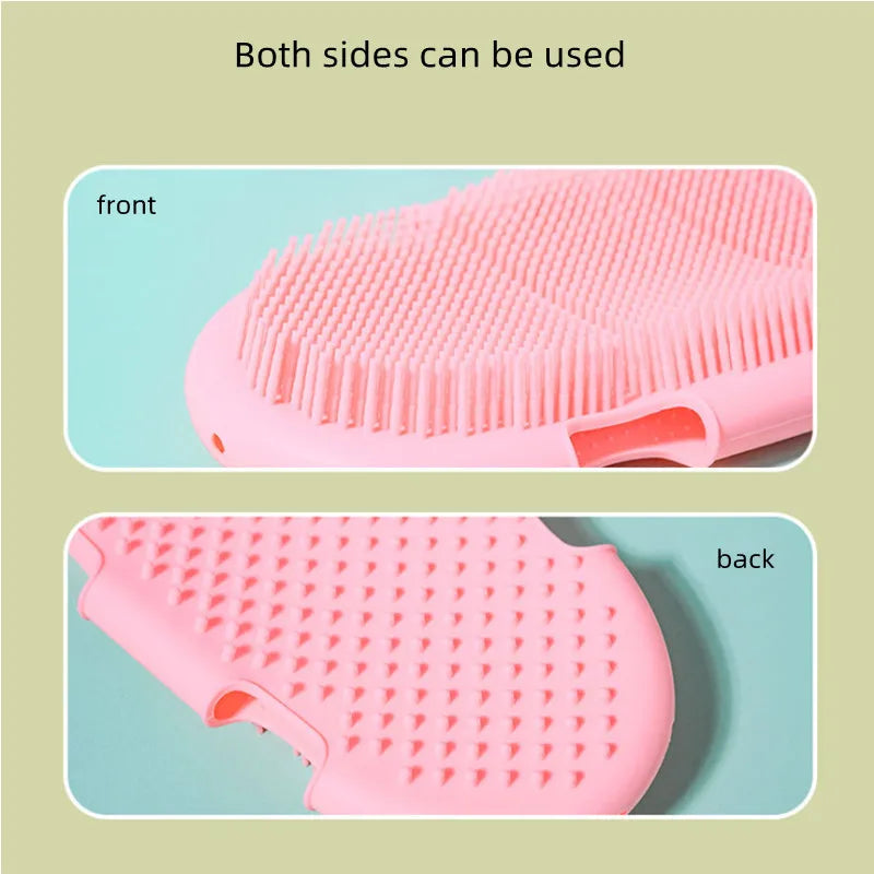 Double-sided pink silicone pet bath brush and grooming glove for gentle massage and exfoliation.