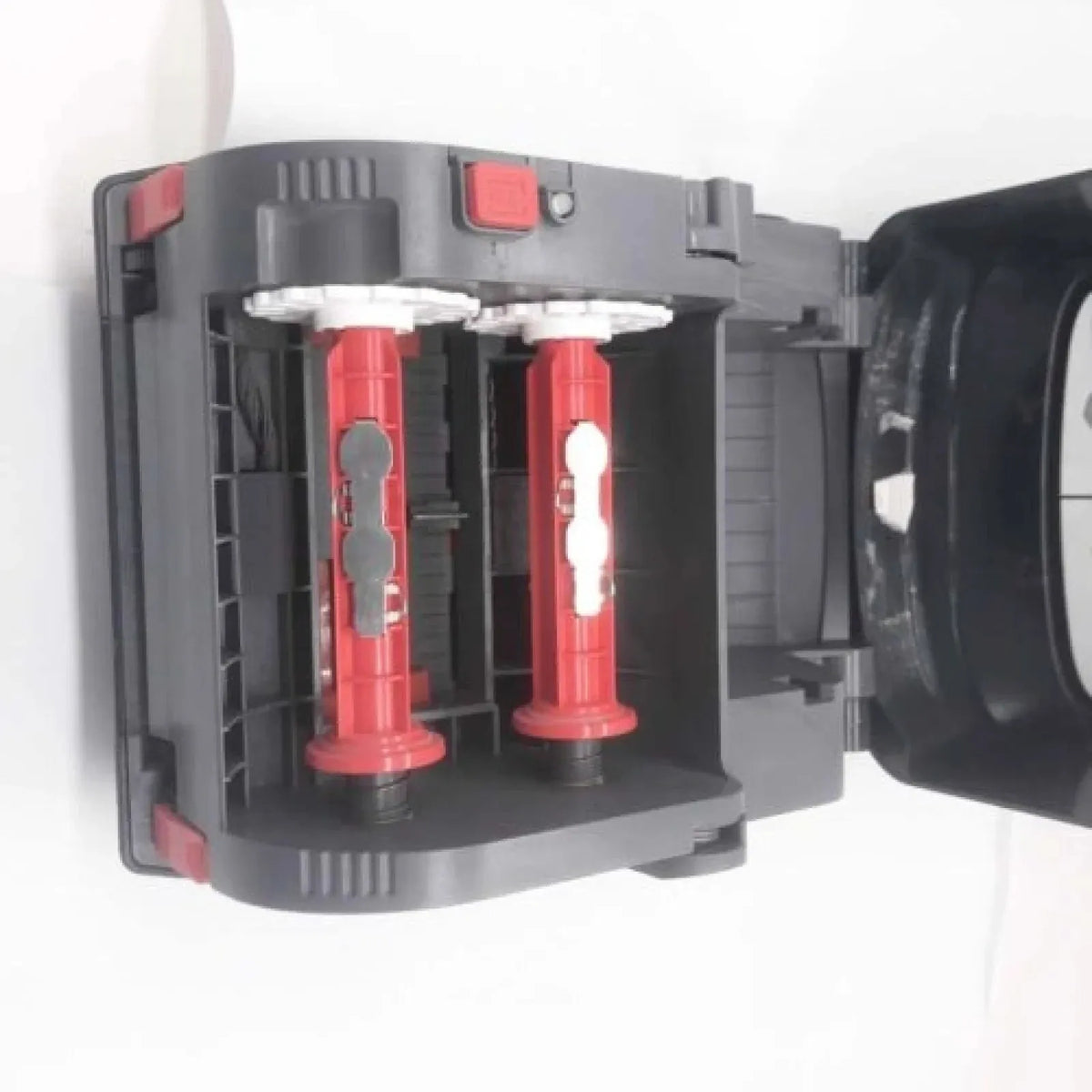 Barcode label printer part interior with two red ribbon spools and black frame