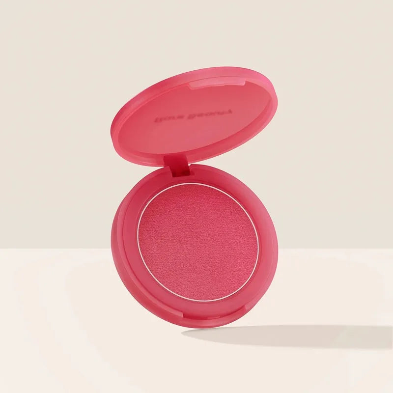 Rare Beauty powder blush compact in vibrant pink with a matte, soft-mud texture, open for full product visibility.