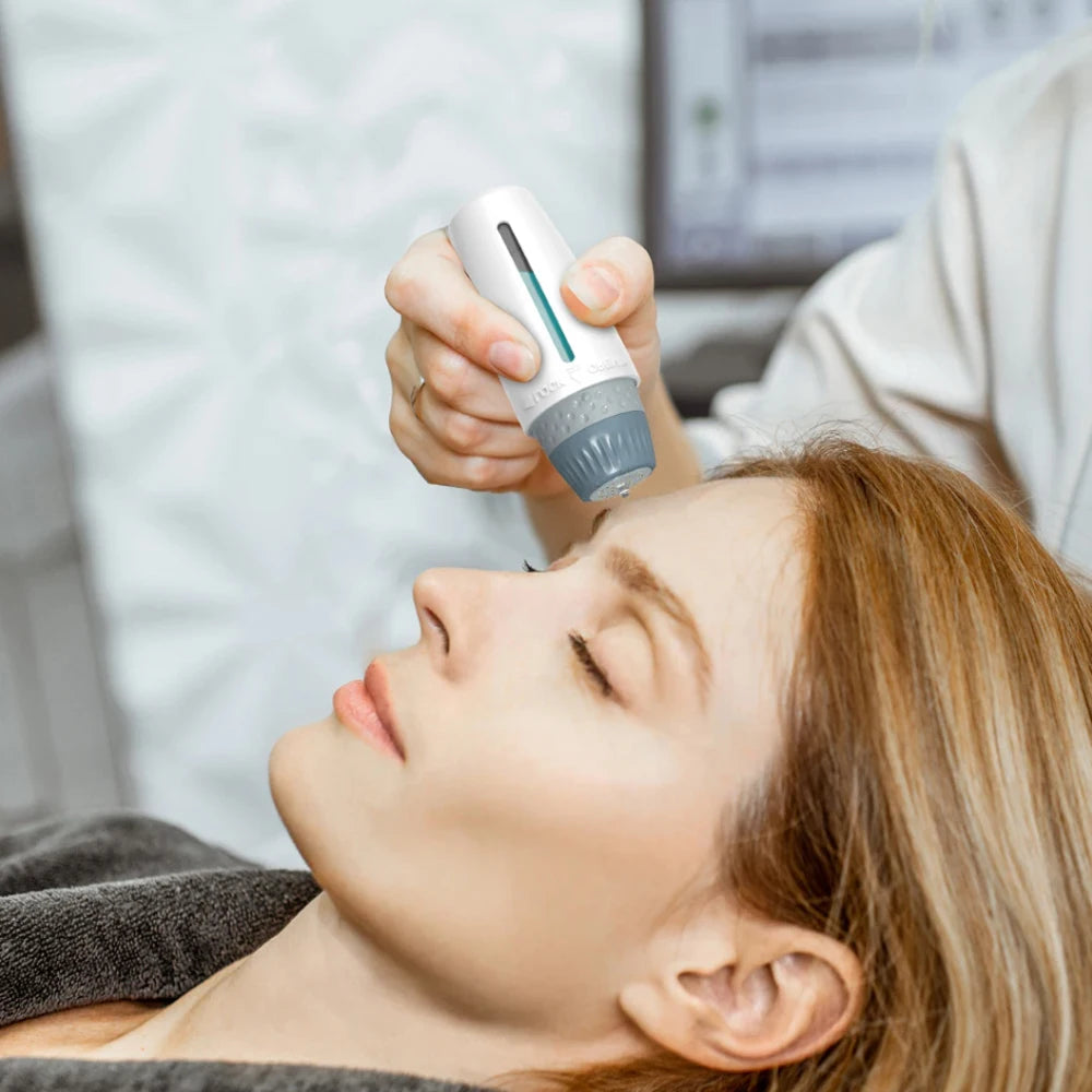 BIO H24 microneedle derma stamp tool for facial skin hydration therapy held over a woman’s forehead.