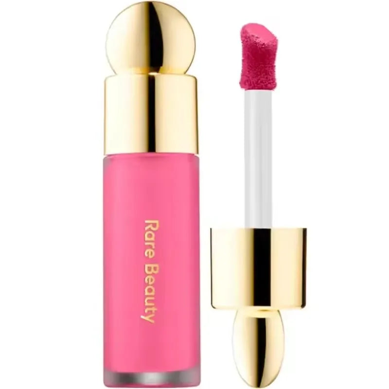 Rare Beauty matte liquid lipstick in vibrant pink, featuring a gold cap, applicator wand, and smooth, rich finish.